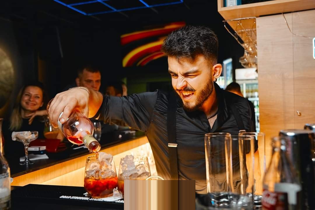 Denis pouring a cocktail at the bar